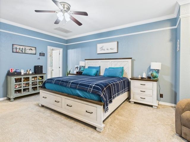 1101 Bunny Rabbit Road Athens, TX 75751 - Photo 16 of 40 a bedroom with a bed and a chandelier