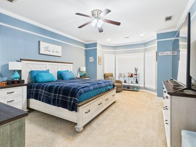 1101 Bunny Rabbit Road Athens, TX 75751 - Photo 17 of 40 a bedroom with a bed and a chandelier