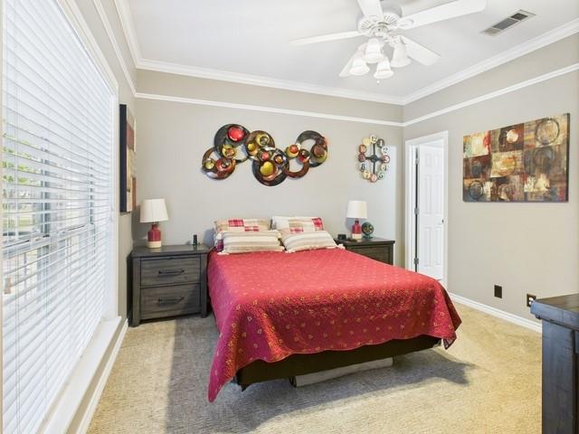 1101 Bunny Rabbit Road Athens, TX 75751 - Photo 22 of 40 a bedroom with a bed and a chandelier