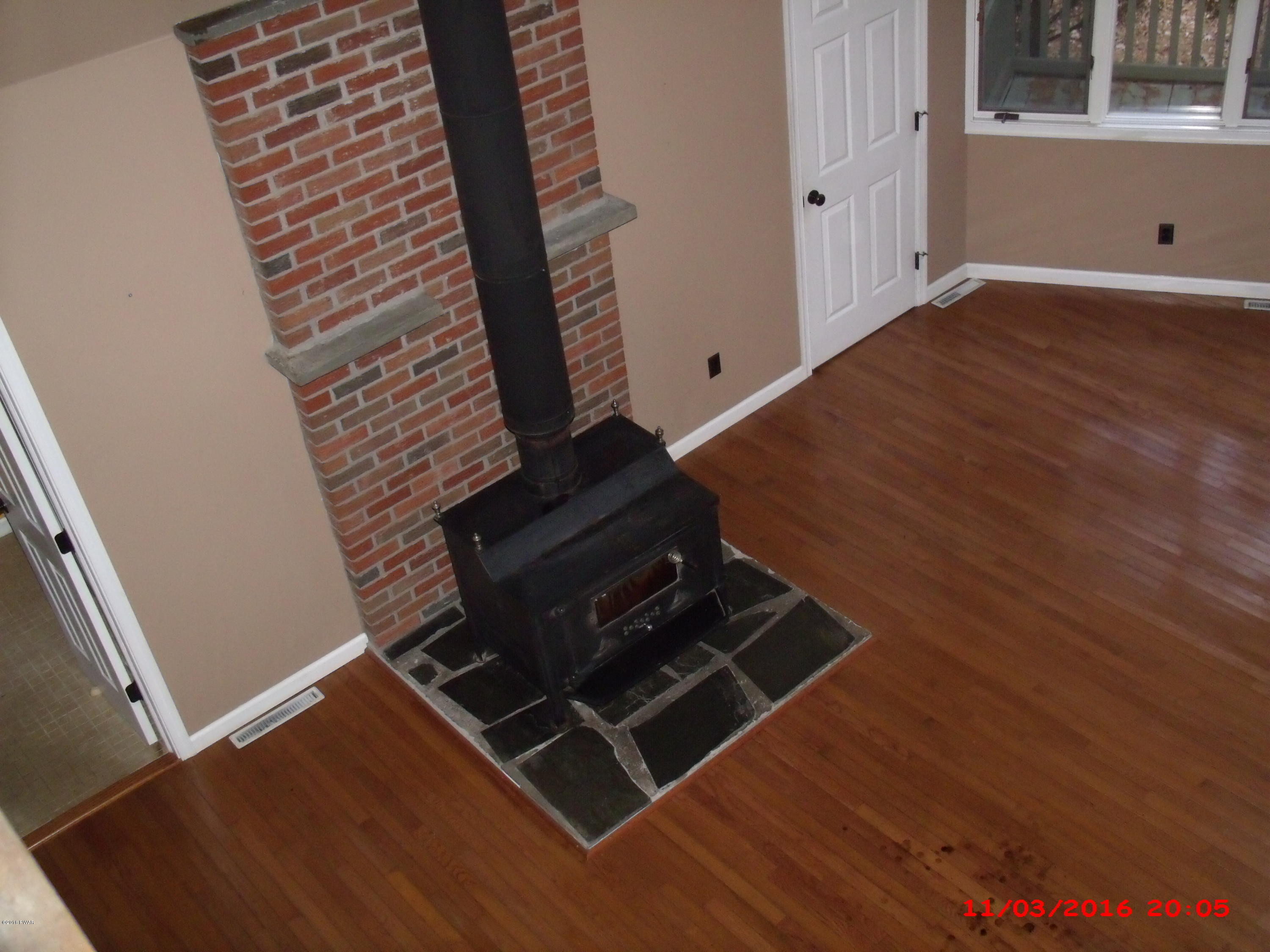 397 Perkins Pond Road Beach Lake, PA 18405 - Photo 5 of 25 a view of an empty room with wooden floor and stairs