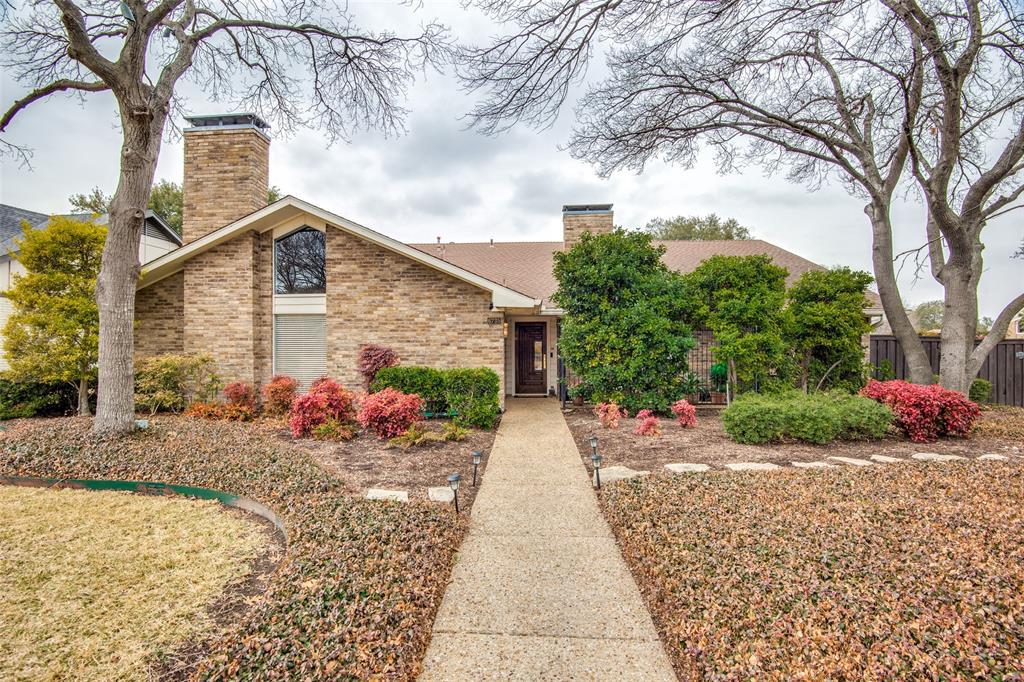 a front view of a house with a yard and a garage