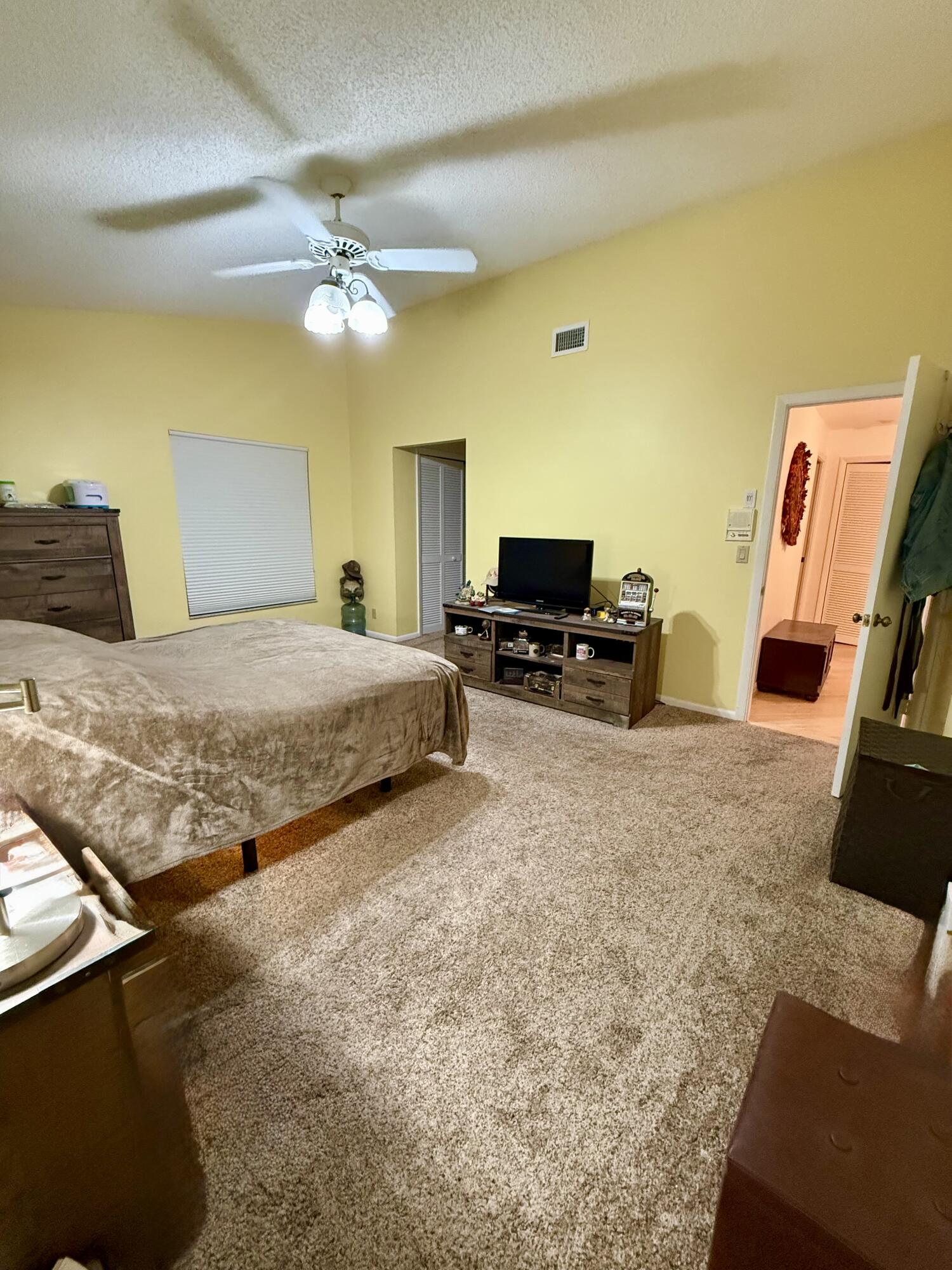 7024 Golf Pointe Circle Tamarac, FL 33321 - Photo 11 of 28 a bedroom with a bed flat screen tv and dresser