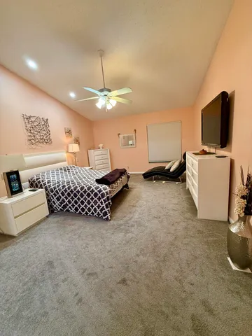 a bedroom with a bed and a lamp