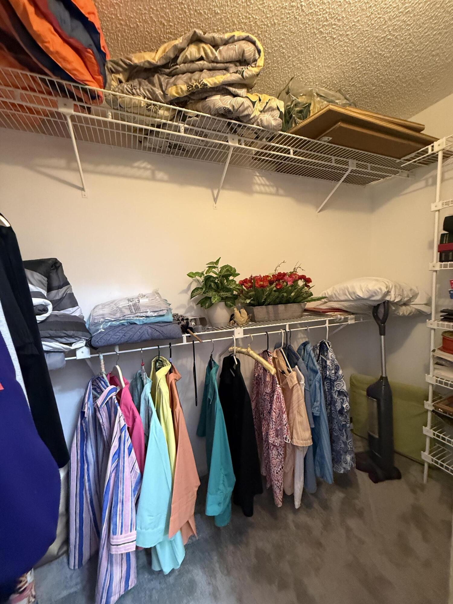 7024 Golf Pointe Circle Tamarac, FL 33321 - Photo 21 of 28 a view of walk in closet with clothes and shoes