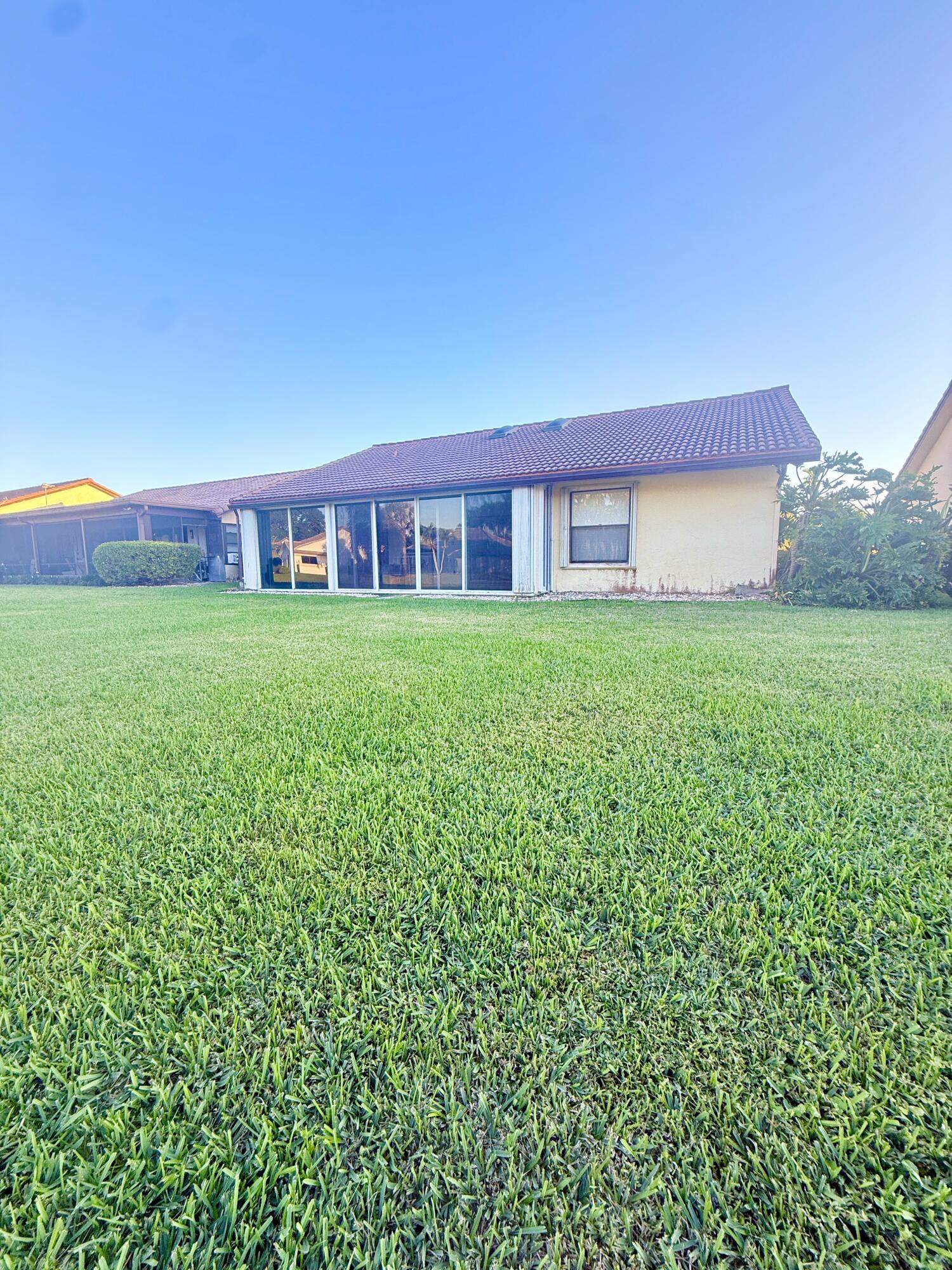 7024 Golf Pointe Circle Tamarac, FL 33321 - Photo 26 of 28 a house view with a garden space
