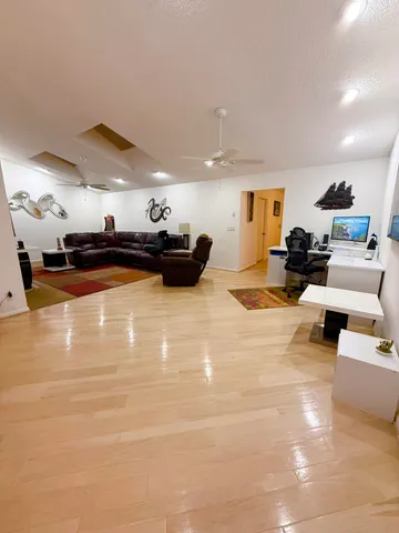 a room with a bed window and a television