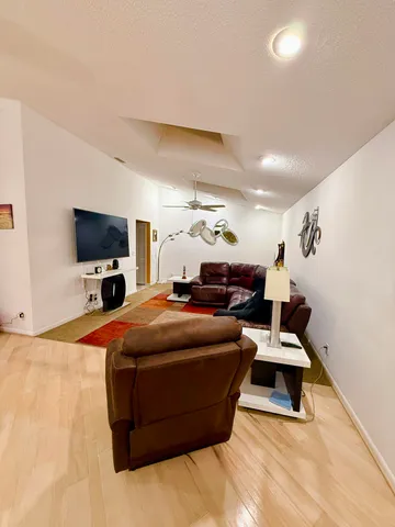 a living room with furniture and wooden floor