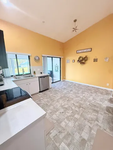 a view of a dining room with furniture and chandelier
