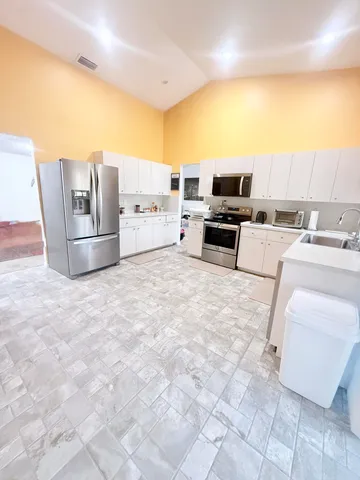 a large white bed in a white room