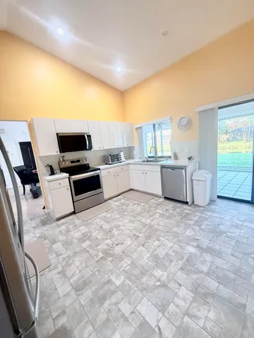 a bedroom with a bed flat screen tv and dresser
