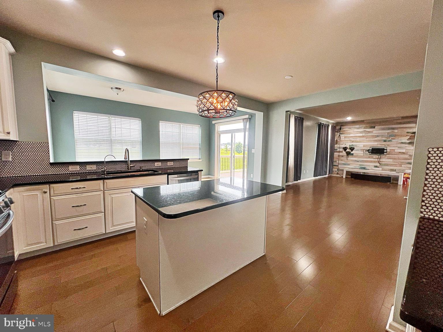 1147 Cardigan Road Middletown, DE 19709 - Photo 11 of 32 a kitchen with granite countertop a sink cabinets and stainless steel appliances