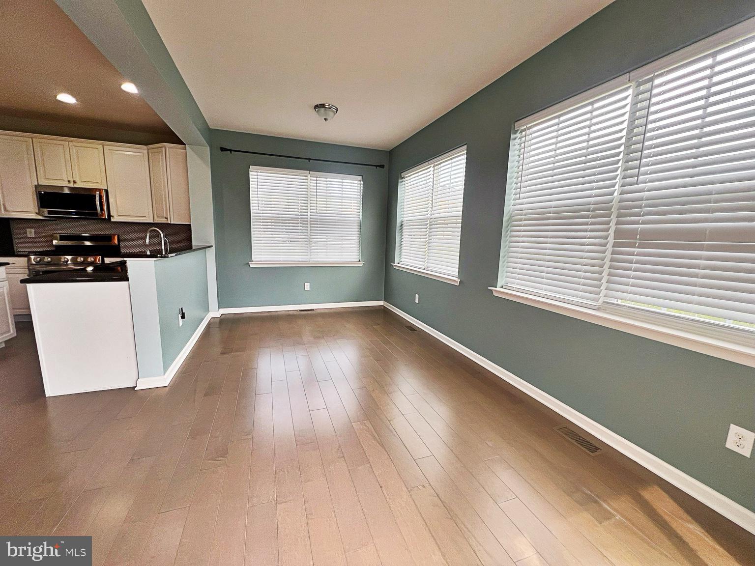 1147 Cardigan Road Middletown, DE 19709 - Photo 12 of 32 a view of a kitchen with wooden floor and electronic appliances