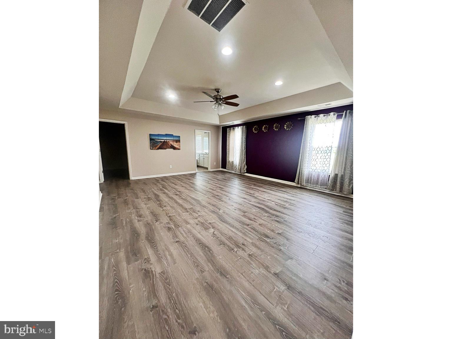 1147 Cardigan Road Middletown, DE 19709 - Photo 16 of 32 an empty room with wooden floor and windows