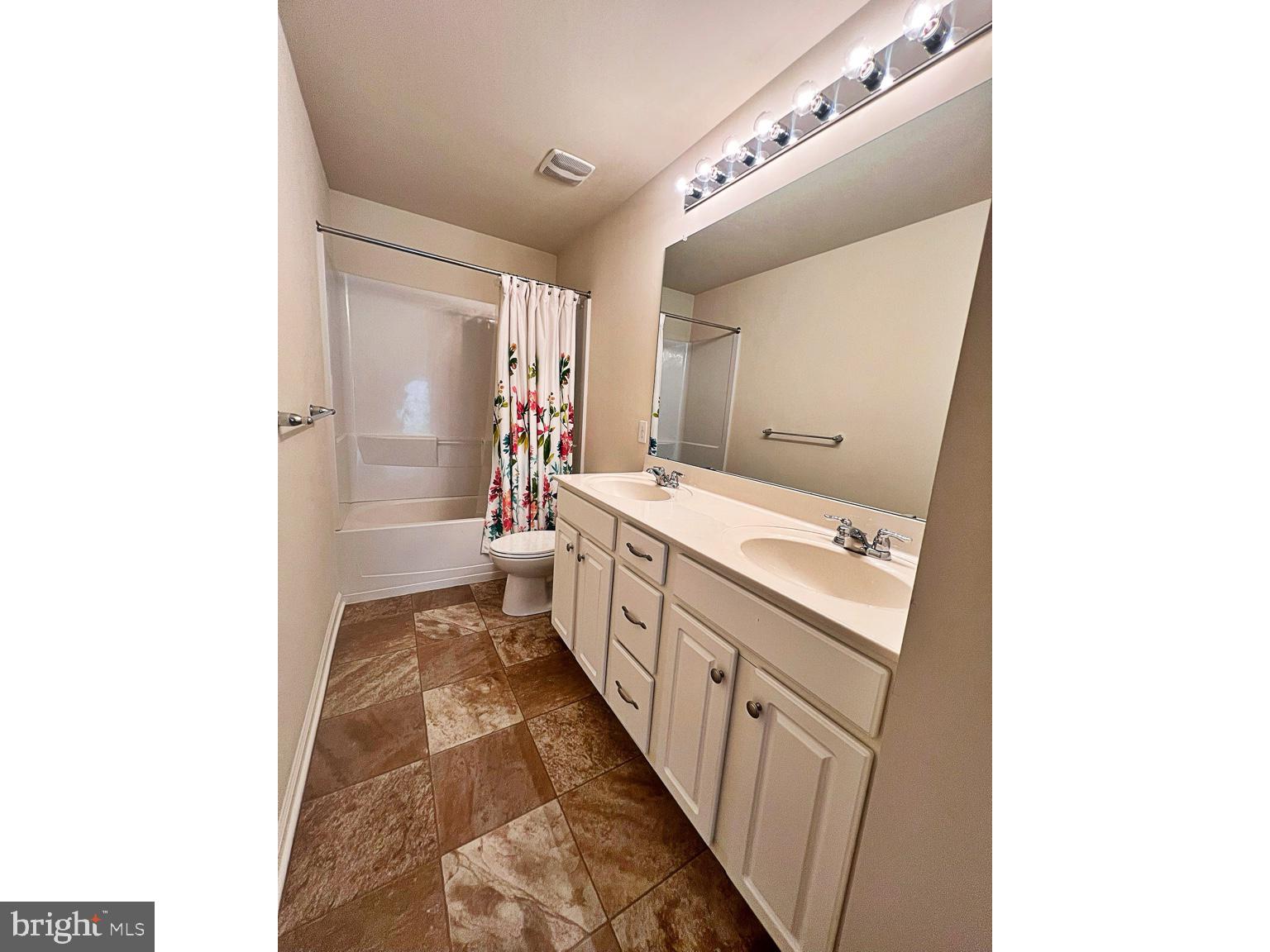 1147 Cardigan Road Middletown, DE 19709 - Photo 23 of 32 a bathroom with a double vanity sink a toilet and a mirror