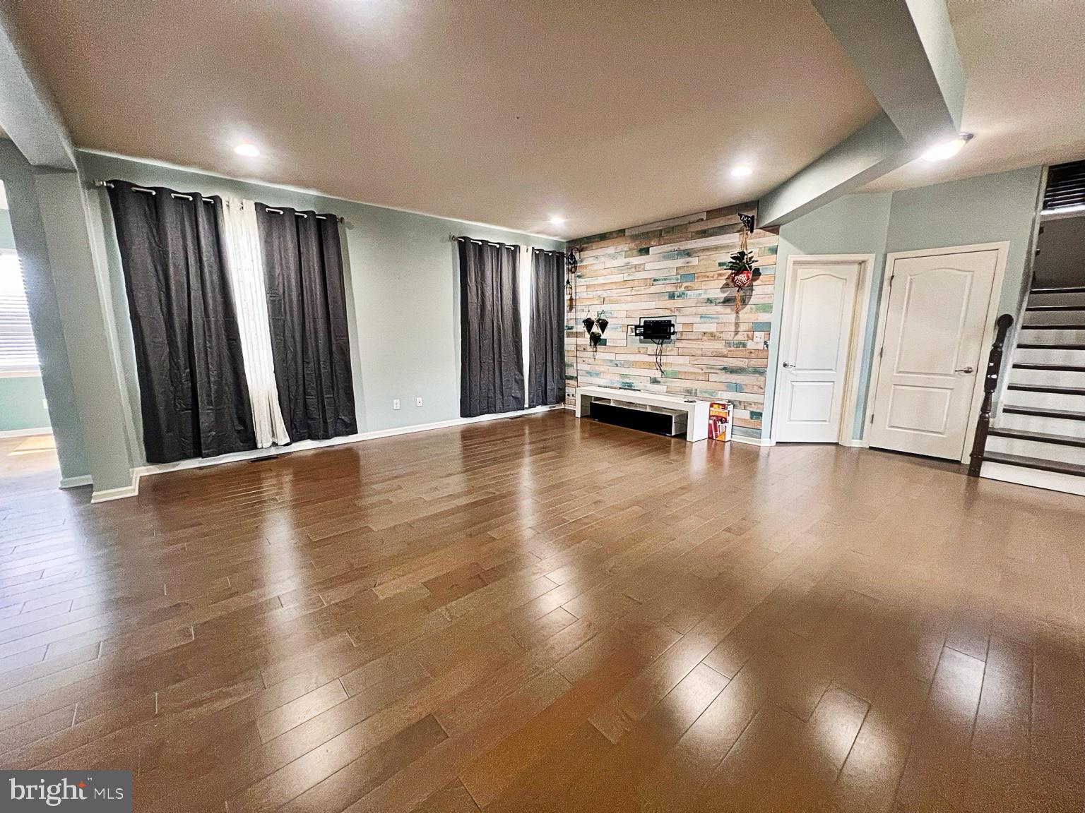 1147 Cardigan Road Middletown, DE 19709 - Photo 6 of 32 a view of an empty room with wooden floor and a window