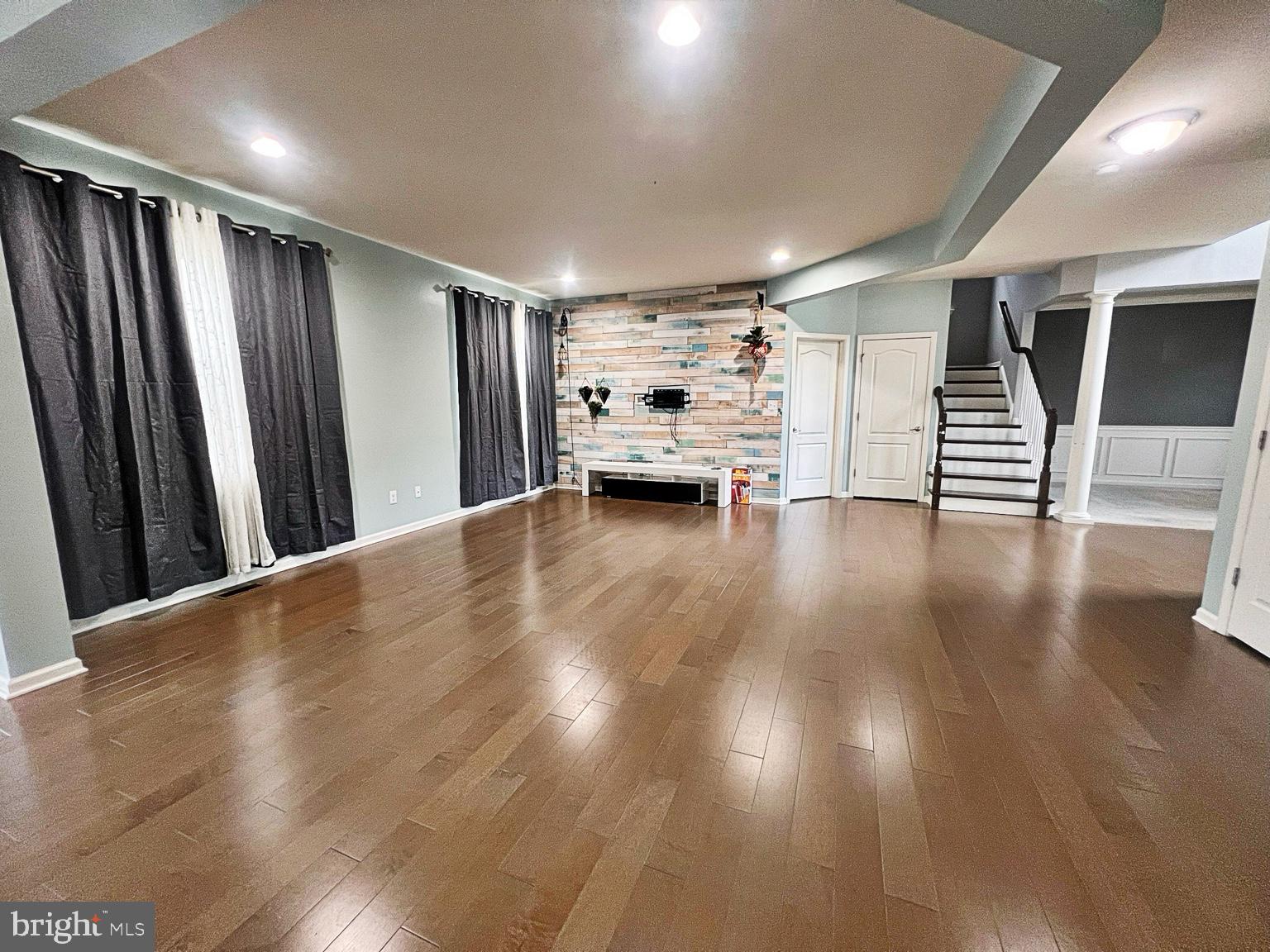 1147 Cardigan Road Middletown, DE 19709 - Photo 8 of 32 a view of a livingroom with wooden floor and staircase