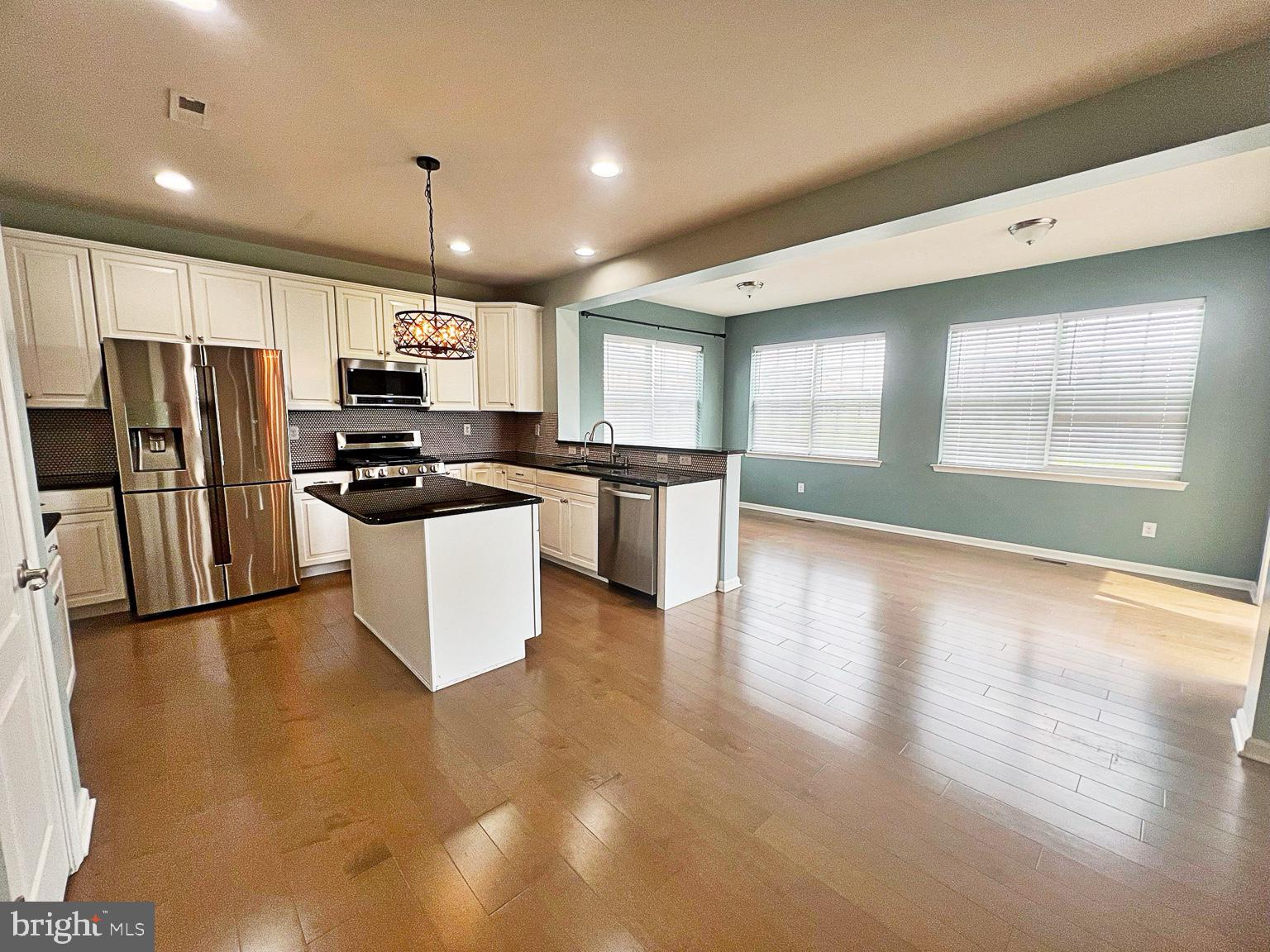 1147 Cardigan Road Middletown, DE 19709 - Photo 9 of 32 a kitchen with stainless steel appliances granite countertop a refrigerator a stove a sink a microwave a counter space and cabinets