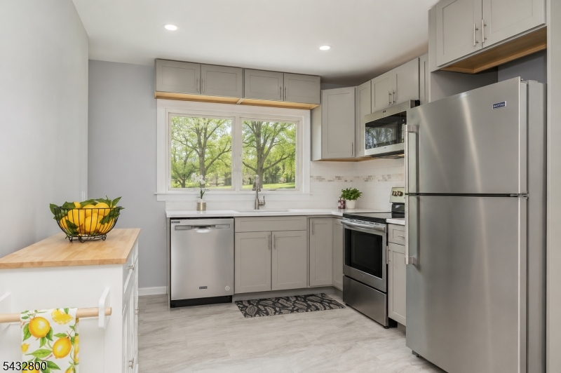 3 Castle Rock Road Lake Hopatcong, NJ 07849 - Photo 5 of 14 a kitchen with a refrigerator sink and stove