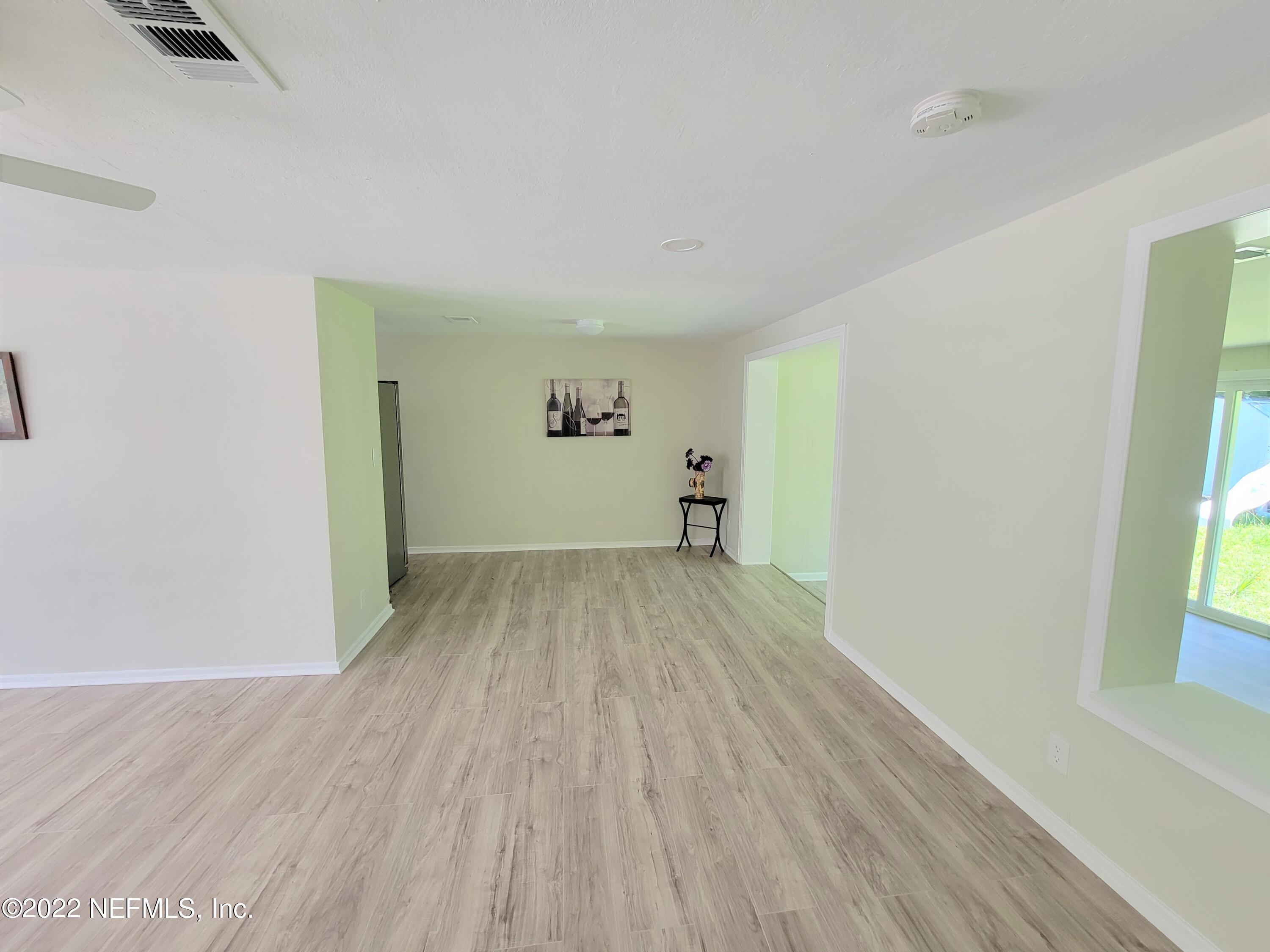 5118 Spring Glen Road Jacksonville, FL 32207 - Photo 12 of 33 an empty room with wooden floor and windows