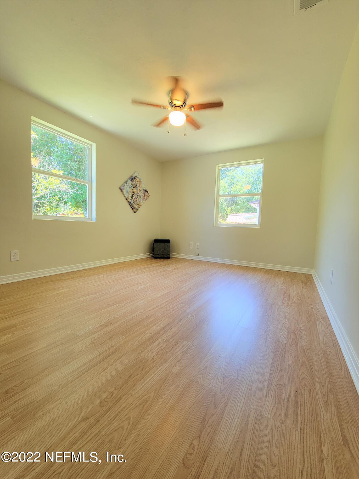 5118 Spring Glen Road Jacksonville, FL 32207 - Photo 23 of 33 wooden floor in an empty room with a window