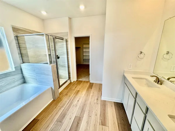 a bathroom with a tub sink and shower