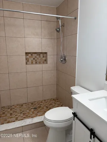 a white toilet sitting next to a bathroom sink