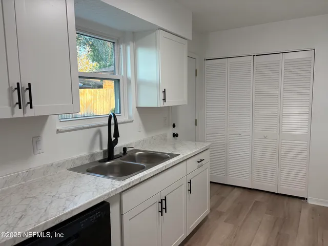 a kitchen with a sink and cabinets