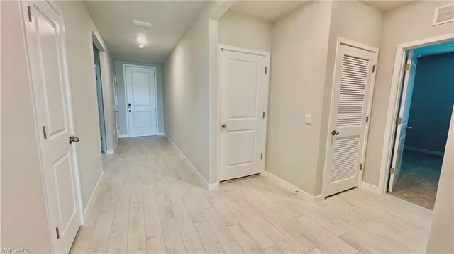 an empty room with wooden floor and door