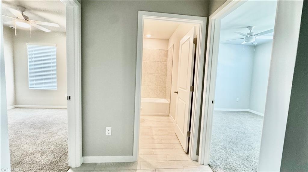 17710 Shade Tree Loop Babcock Ranch, FL 33982 - Photo 16 of 28 view of a bathroom from a corridor