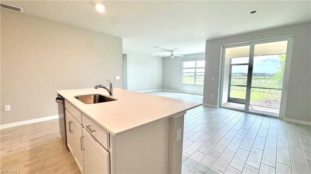 17710 Shade Tree Loop Babcock Ranch, FL 33982 - Photo 2 of 28 a kitchen with a sink and large window