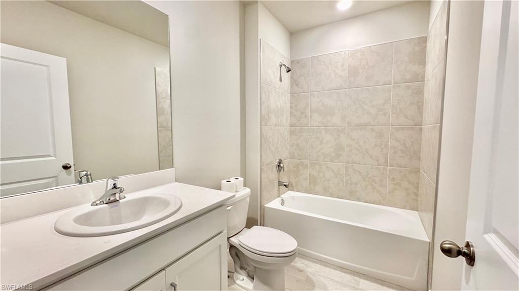 17710 Shade Tree Loop Babcock Ranch, FL 33982 - Photo 22 of 28 a bathroom with a sink toilet and shower