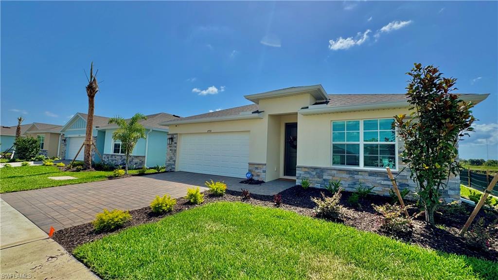 17710 Shade Tree Loop Babcock Ranch, FL 33982 - Photo 27 of 28 a view of a house with backyard and garden