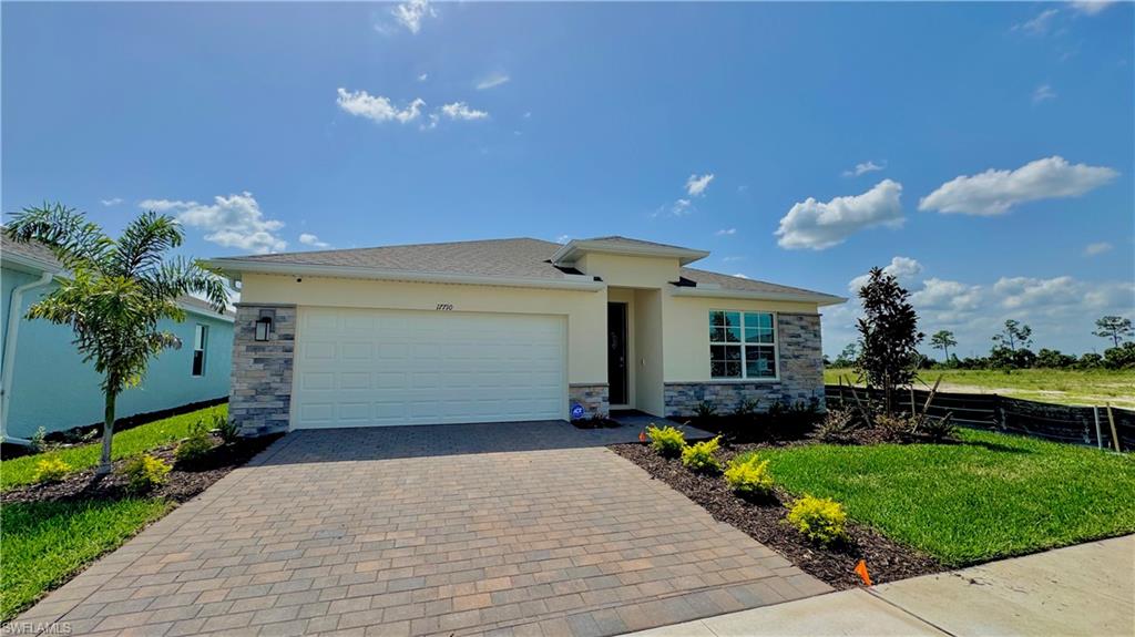 17710 Shade Tree Loop Babcock Ranch, FL 33982 - Photo 28 of 28 a front view of a house with garden