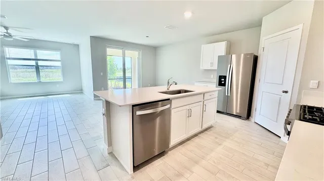 a kitchen with stainless steel appliances a white stove top oven and a refrigerator