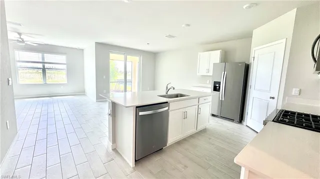 a kitchen with a sink stove and refrigerator