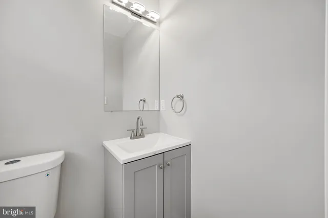 a bathroom with a sink a toilet and mirror
