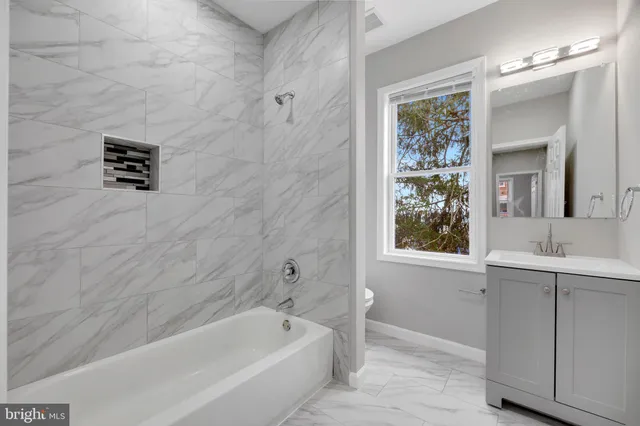 a bathroom with a bathtub and a sink