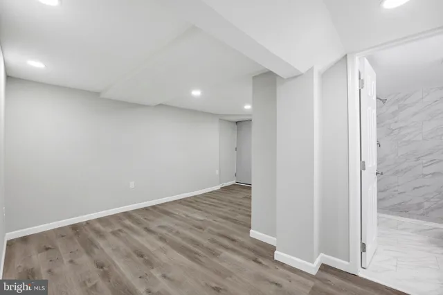 a view of an empty room with wooden floor