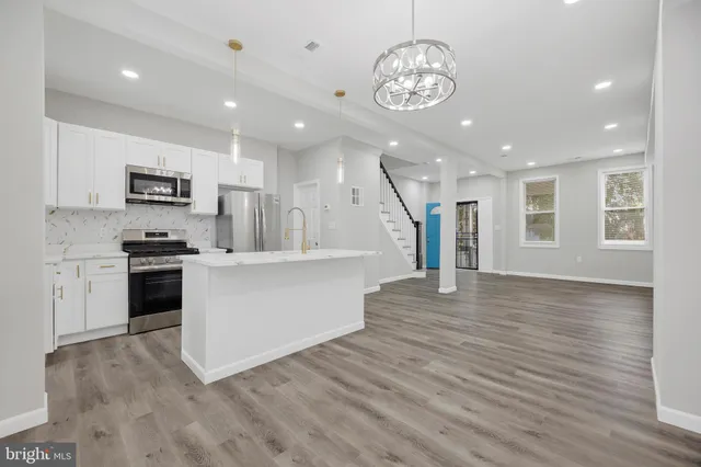 a view of kitchen with cabinets and wooden floor