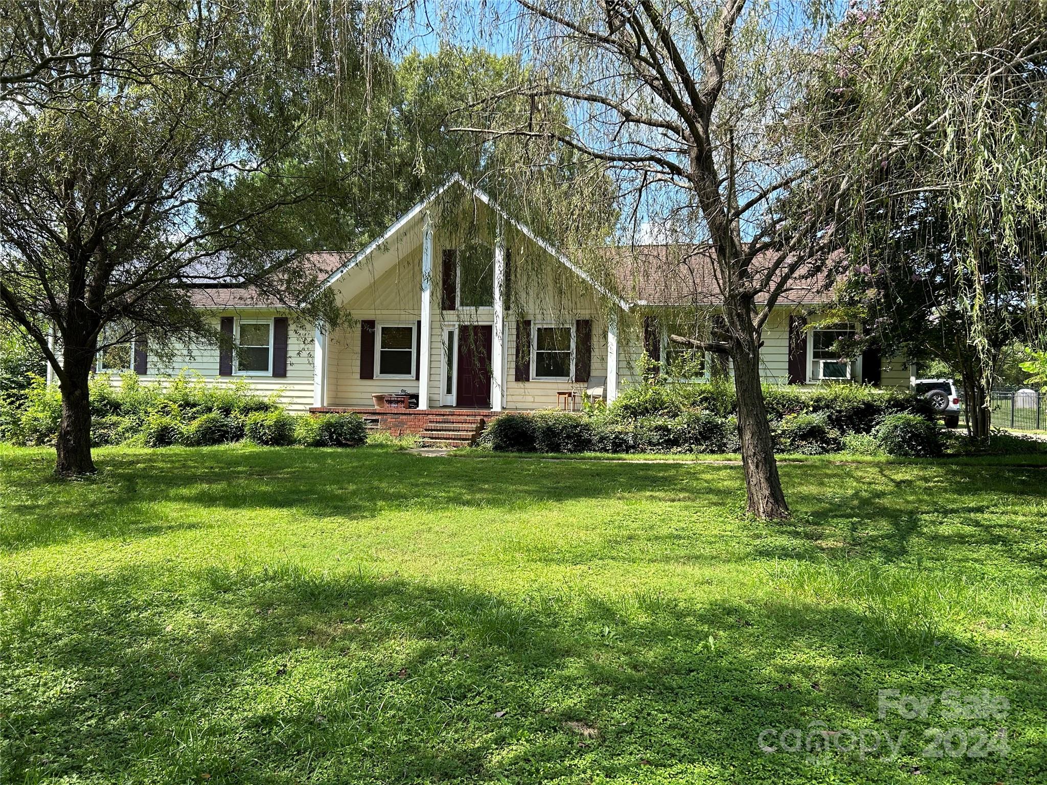 1068 Perth Road Troutman, NC 28166 - Photo 1 of 2 a front view of house with yard and green space