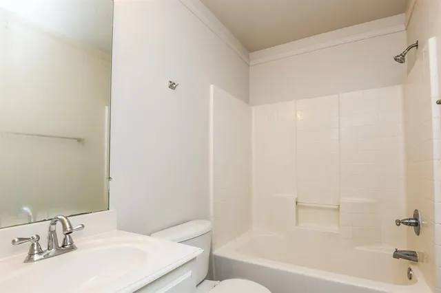 a bathroom with a bathtub a sink and a mirror