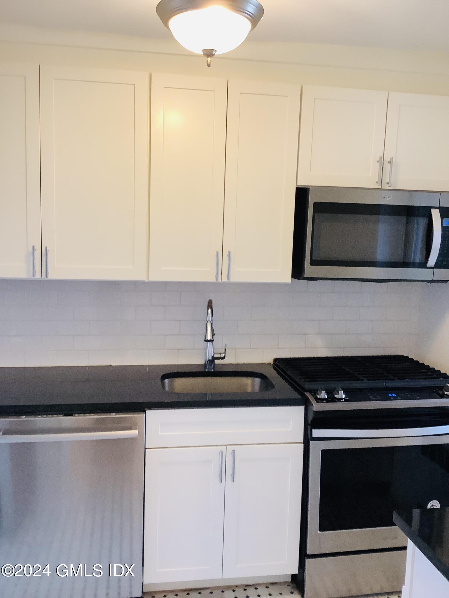 20 Church Street, Unit A26 Greenwich, CT 06830 - Photo 9 of 13 a kitchen with a sink and cabinets