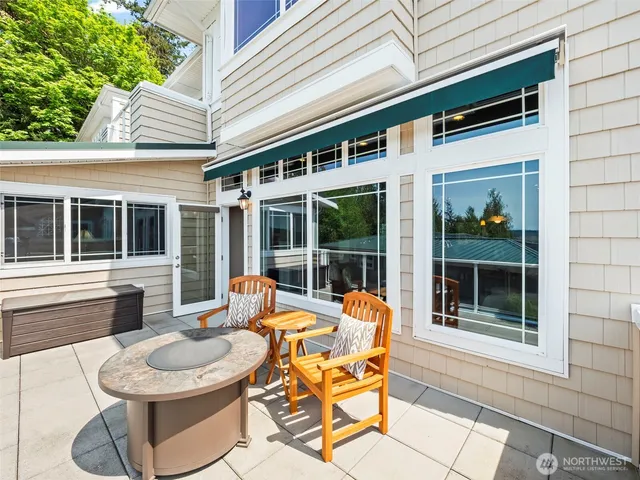 a view of a patio with couches table and chairs and potted plants