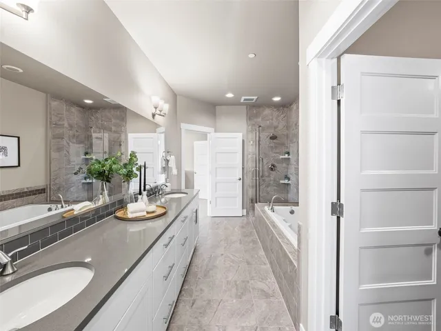 a spacious bathroom with a double vanity sink and a large mirror