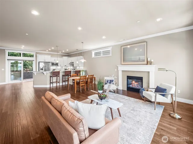a living room with furniture fireplace and window