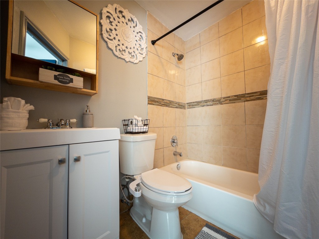 7124 Avenue F, Unit 1 Houston, TX 77011 - Photo 5 of 12 a bathroom with a sink a toilet and shower