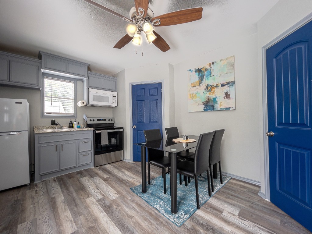 7124 Avenue F, Unit 1 Houston, TX 77011 - Photo 7 of 12 a kitchen with a table chairs and refrigerator