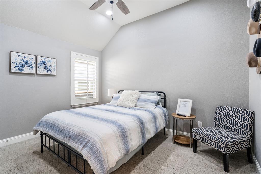 1501 Snowdrop Drive Prosper, TX 75078 - Photo 22 of 27 a bedroom with a bed and a lamp on dresser