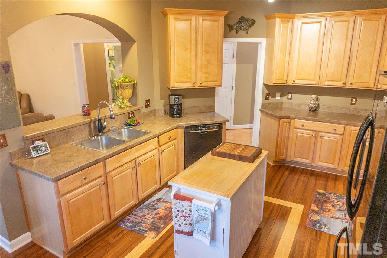 106 Braid Court Raleigh, NC 27603 - Photo 11 of 30 a kitchen with a sink stove and cabinets