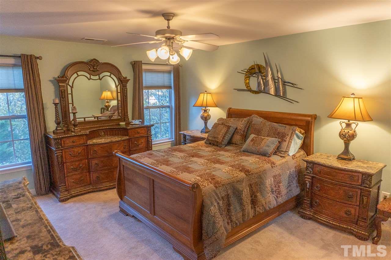 106 Braid Court Raleigh, NC 27603 - Photo 17 of 30 a bedroom with a bed and a dresser